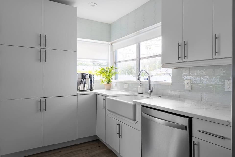 Sparkling clean kitchen with stainless appliances and quartz countertops