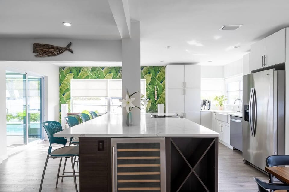Massive quartz bar for casual dining and socializing, with built-in wine cooler