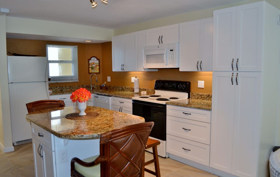 Newly renovated kitchen with granite counters, island seats 4.