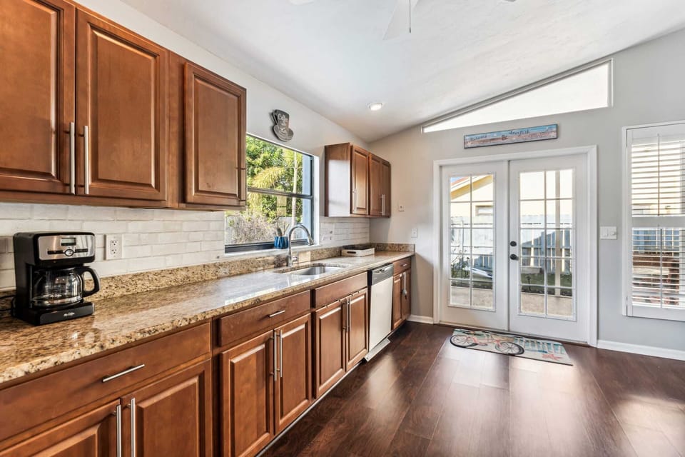 A view down the long counter towards the French doors leading to the screened lanai