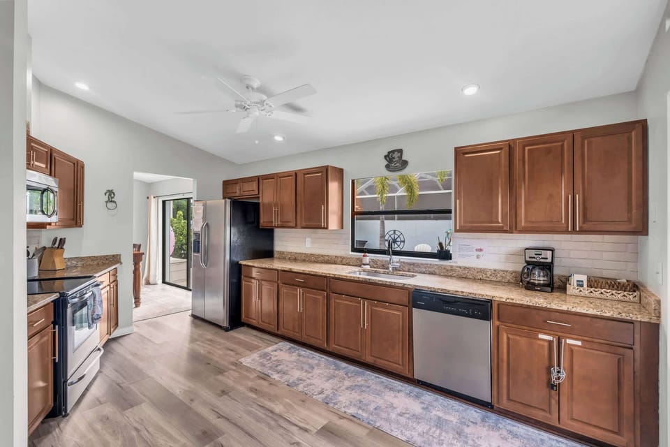 The long counter in the kitchen looks out towards the outdoor pool