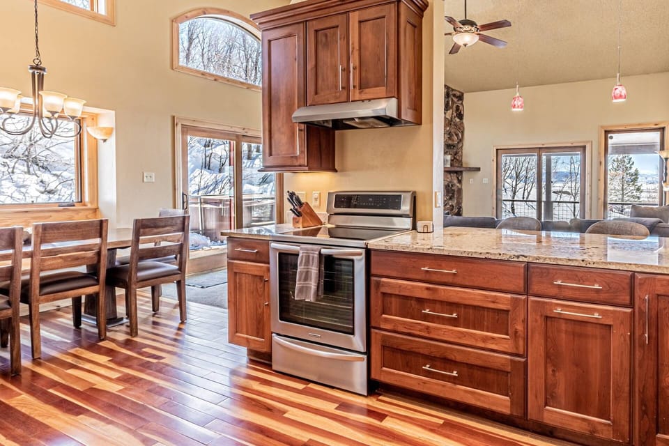 An expansive open-concept kitchen, thoughtfully designed to capture sweeping mountain vistas.