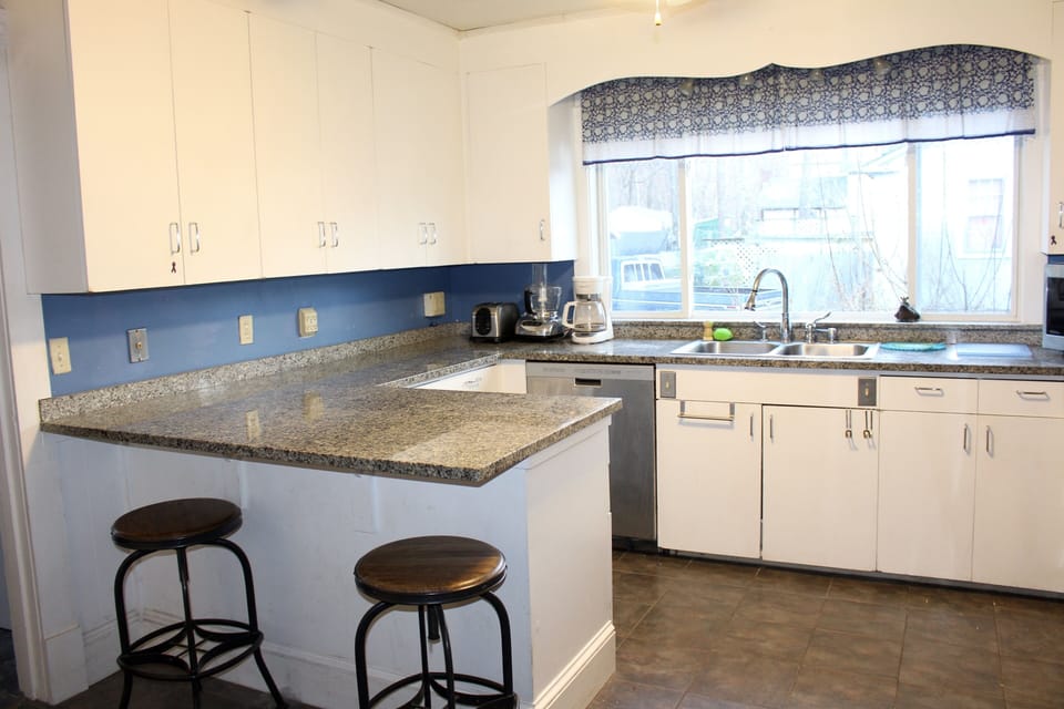 The kitchen features tile floors and granite counters. 