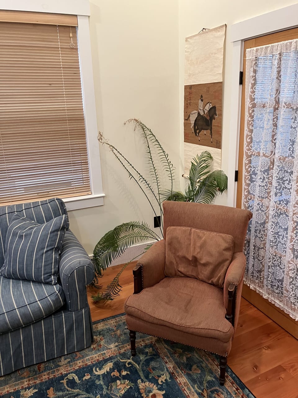 Easy chair next to sofa bed.