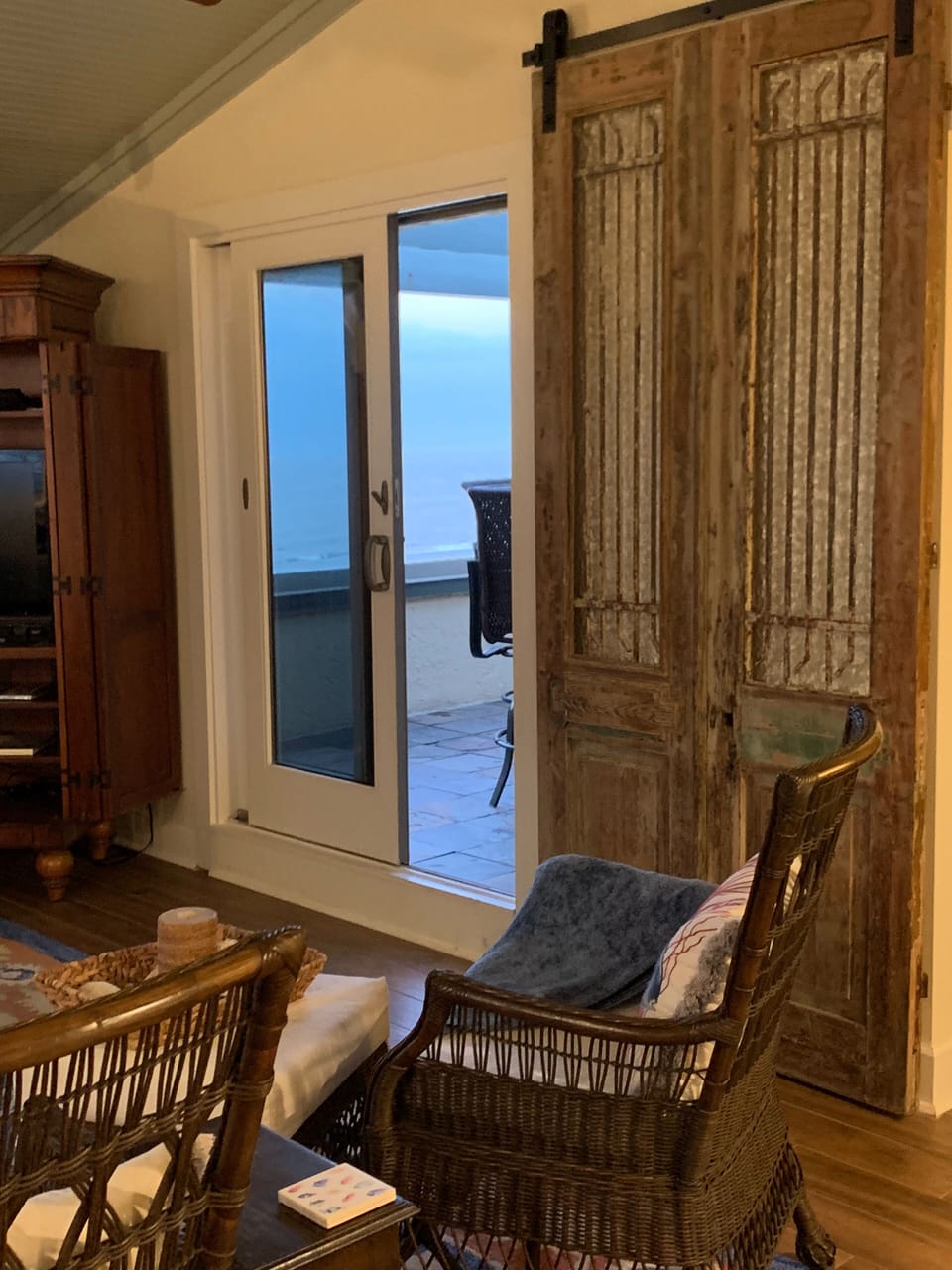 Evening look at porch. Antique door slides to close sleeping/reading den.