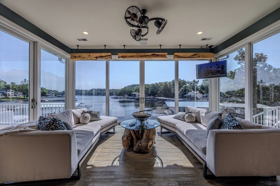 Stunning lakeside view from a cozy, modern living room with ample natural light.