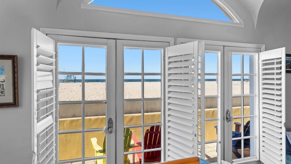 Great room opens up to west-facing patio steps from the beach