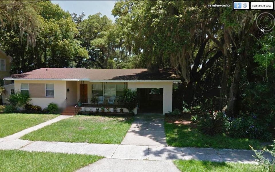 47 Fullerwood nestled in the live oaks with front porch.