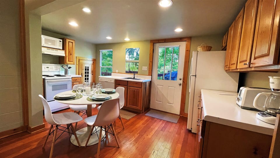 Kitchen and dining area with door to deck and grill