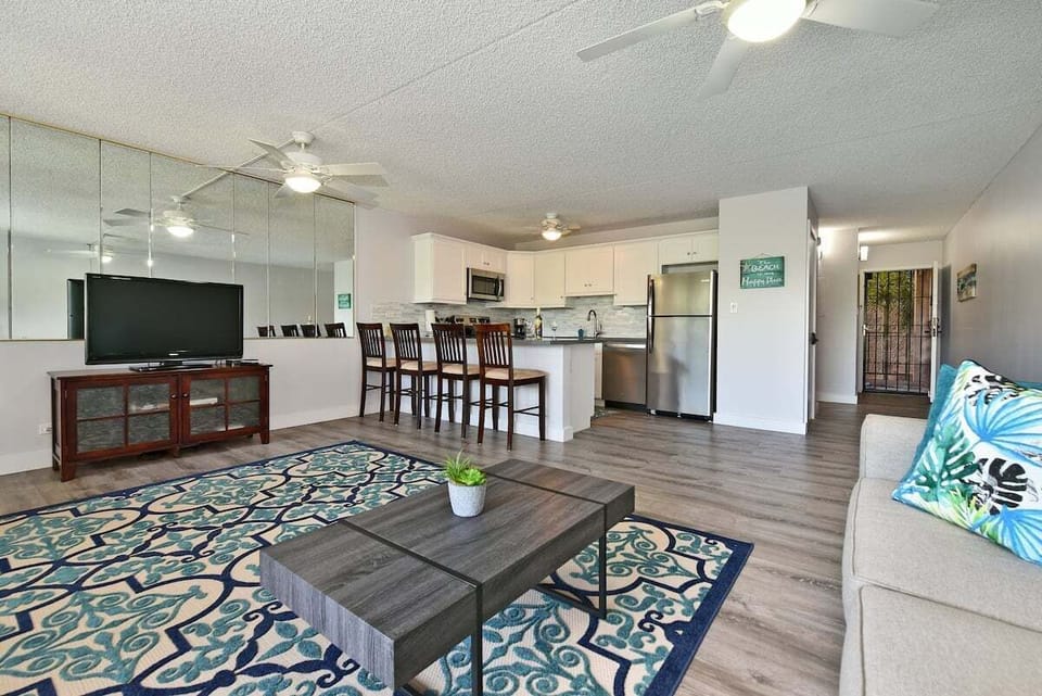 Open living space with sleeper sofa, TV, and dining area.