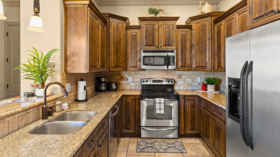 Modern Kitchen with Stainless Steel Appliances Including: Coffee Maker, Dish Washer, and Microwave.