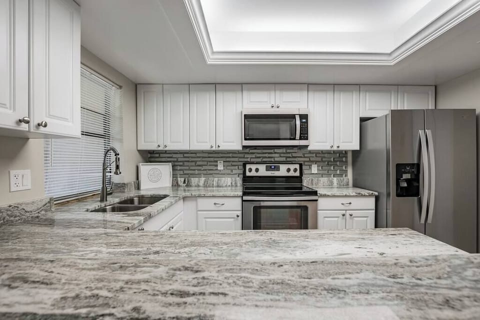 Fantasy Brown granite counters with three-dimensional glass brick backsplash