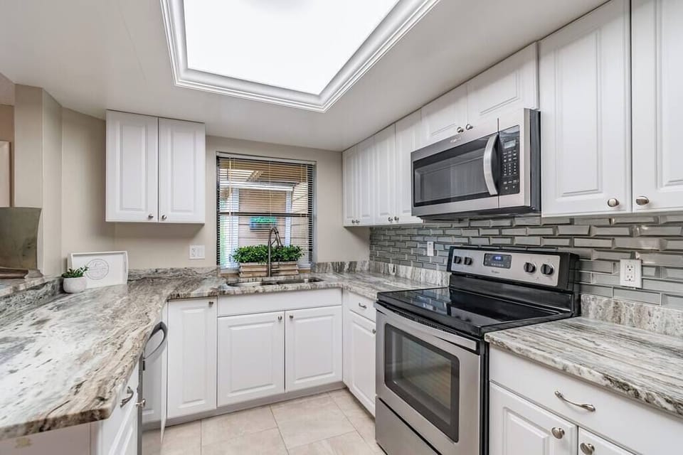 View from hallway into the kitchen and the Fantasy Brown granite counters