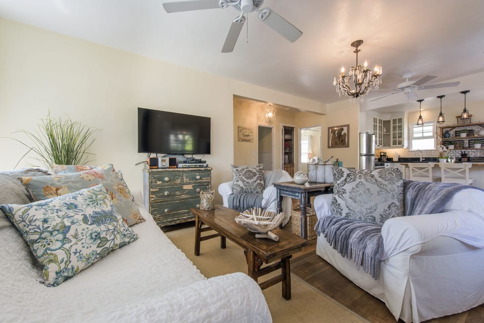 Cosy lounge with throws and feather stuffed cushions.