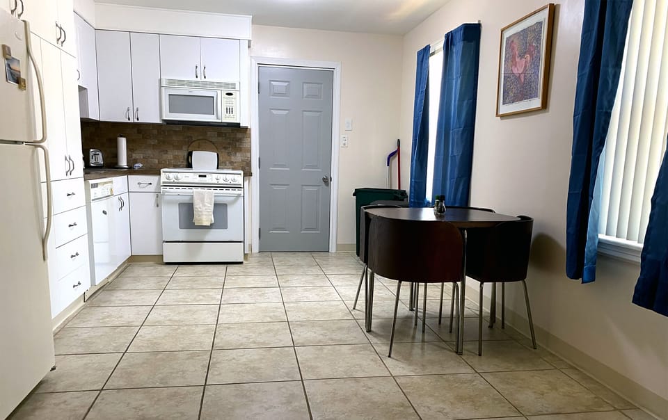 Well-stocked kitchen. Guest laundry machines, are in garage through this door.