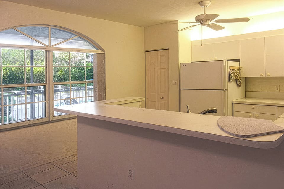Bright, white, fully-equipped kitchen