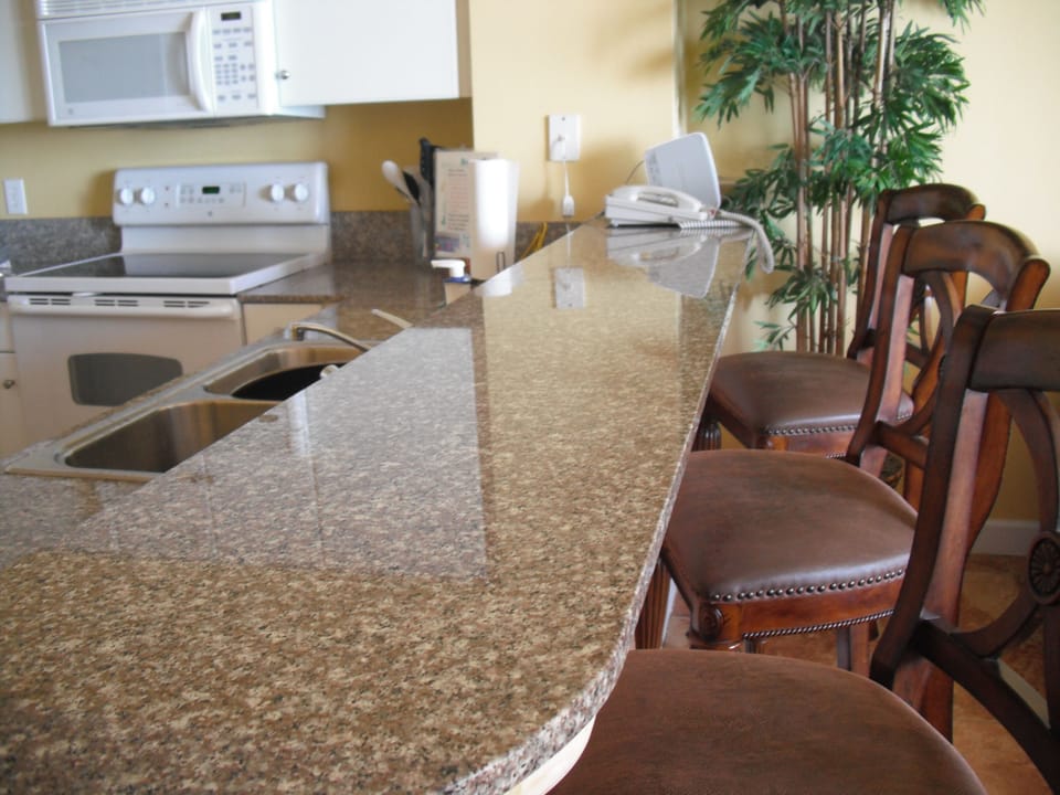 Marble Countertop with high Chairs in Kitchen Area