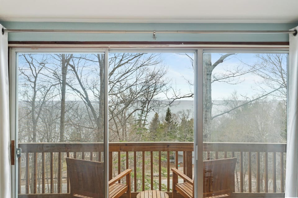 Primary bedroom.  View from the deck in Spring.