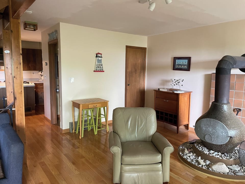 Great Room - living area.  Vintage wood burning stove. bar cabinet, chess table.