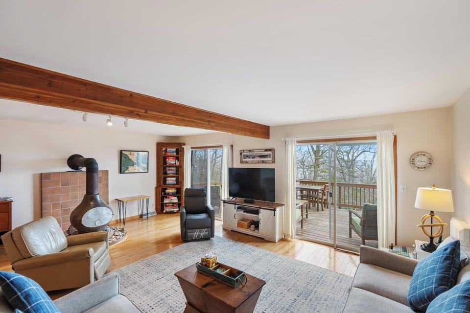 Living room.  Walk out elevated deck with seating area and small dining table.