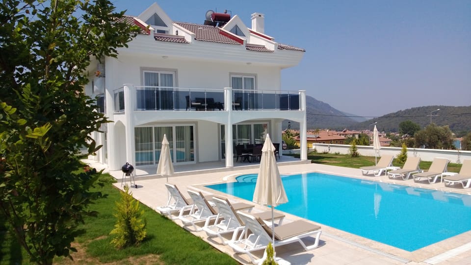 Pool with sun loungers & parasols