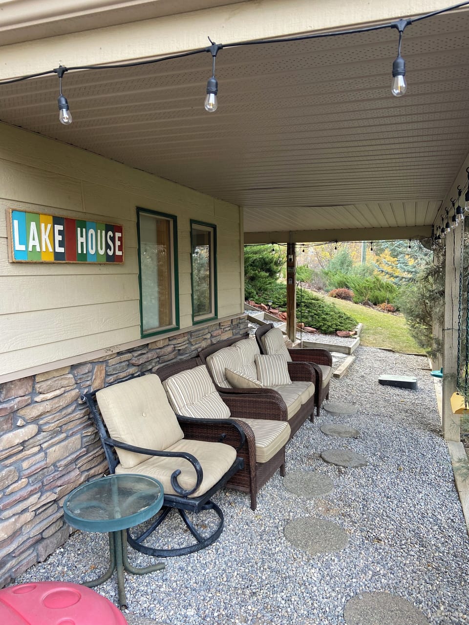 Covered lit sitting area in backyard