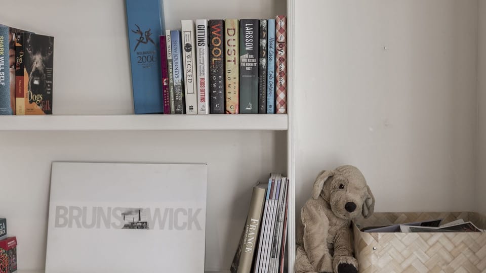 Homely and arty, these  living area shelves have kids/adult books and toys