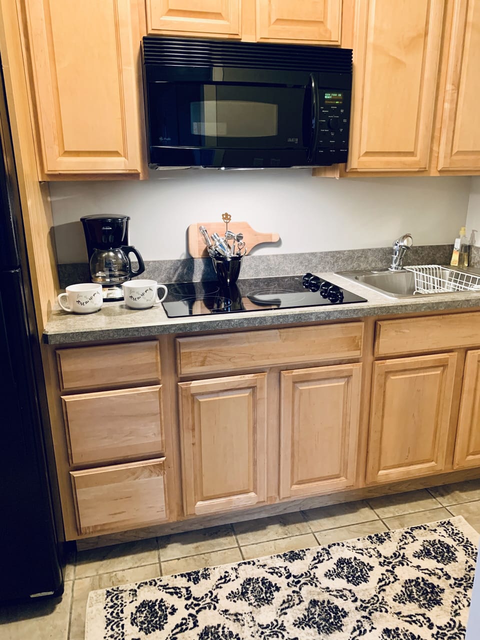 Galley Kitchen w full size refrigerator, cooktop, microwave, coffee maker  ect