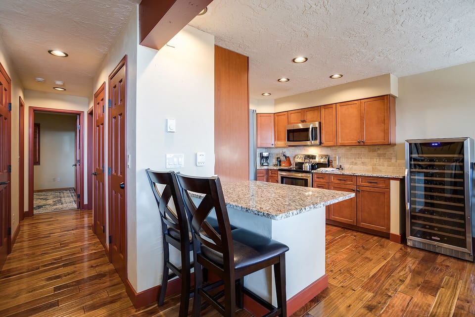 Your gourmet kitchen features granite counters, rich wood cabinets, and premium appliances for memorable meal preparations.