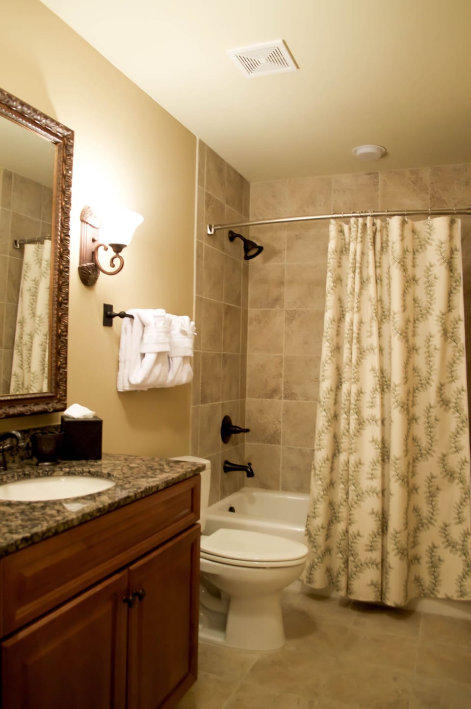 Second bathroom with full tiled shower,tub and granite top.
