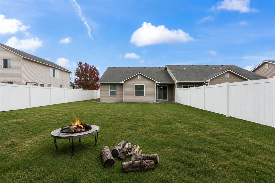 Large back yard with mature fir trees.