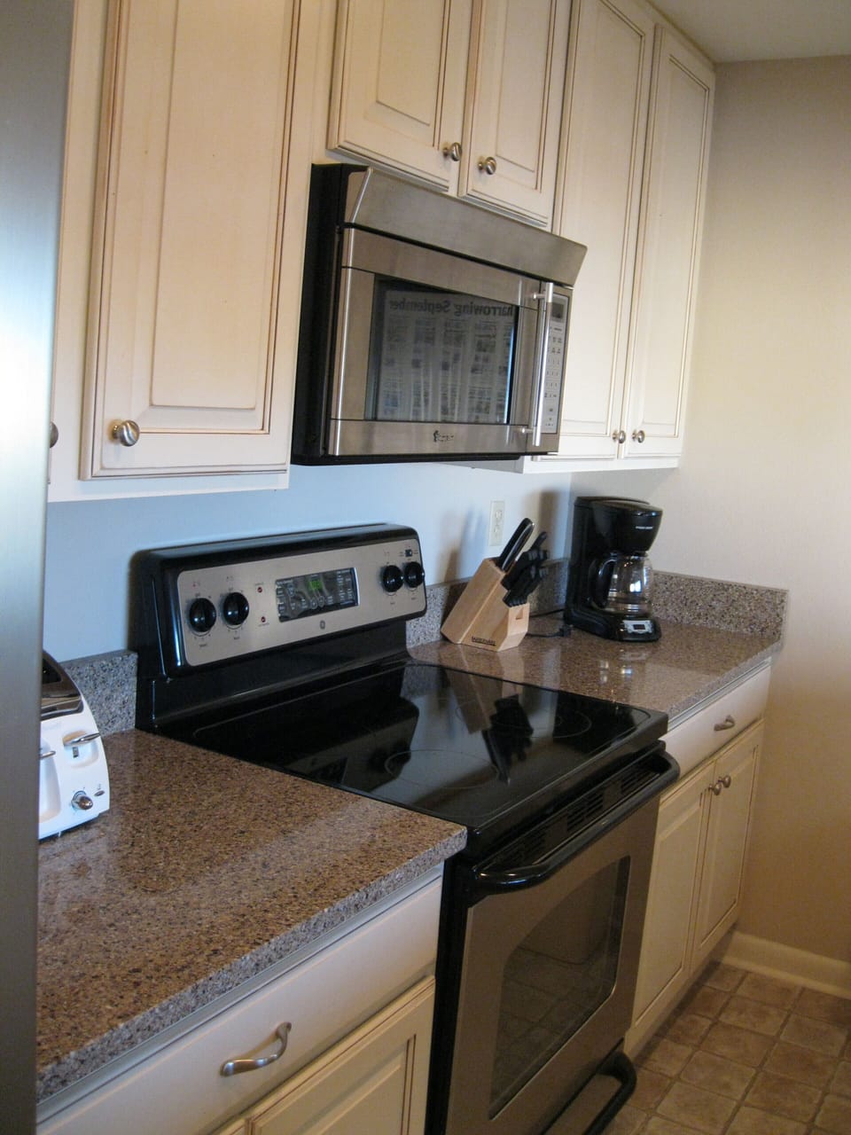 Galley Kitchen with stainless steel appliances, granite counter tops 