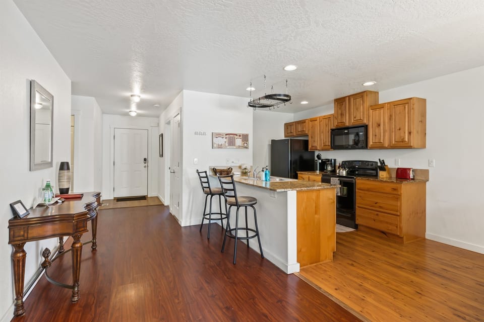 view of the spacious kitchen with upgraded cabinets, granite counters and fully stocked for cooking many meals!