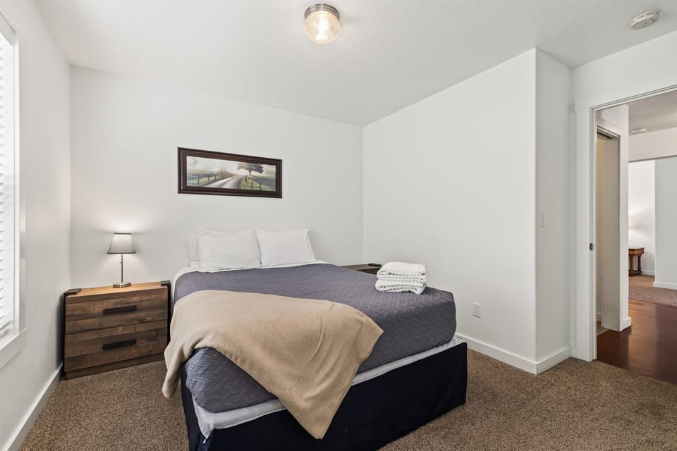 This comfortable queen bed will help you sleep better than at home in bedroom #3.