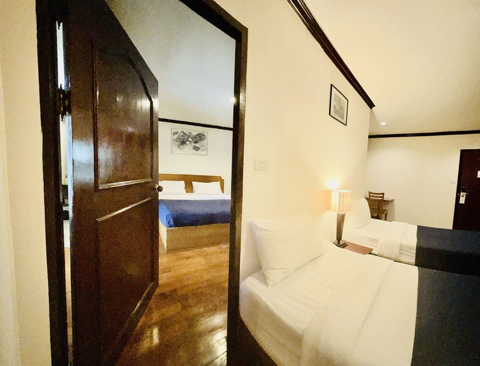 Deluxe Family room | Free minibar items, in-room safe, desk, laptop workspace