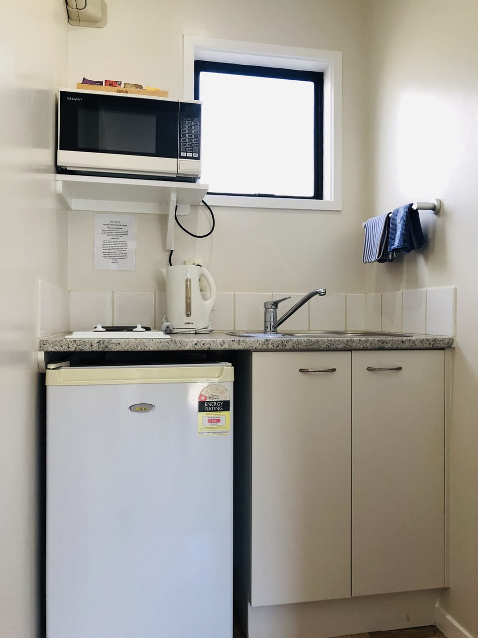 Fridge, coffee/tea maker, electric kettle, cookware/dishes/utensils