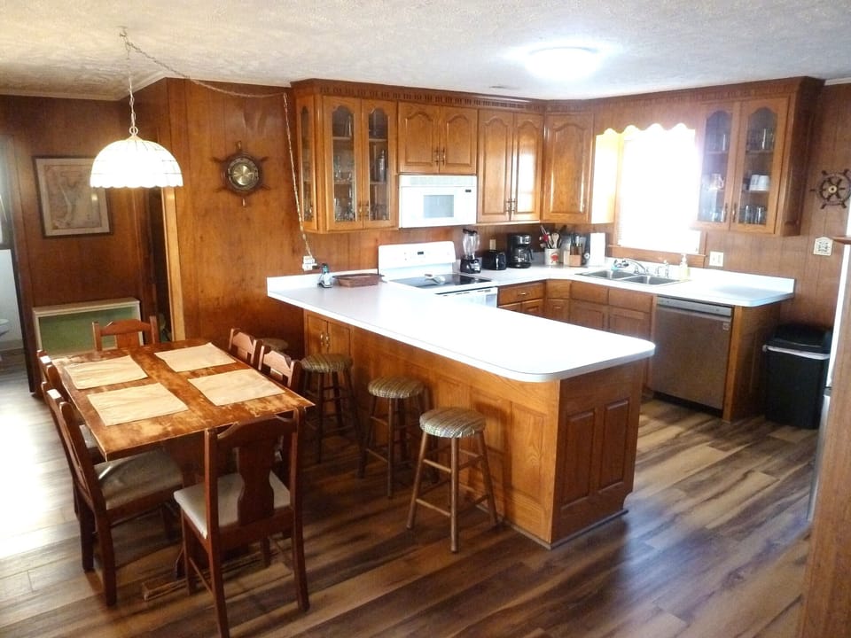 Six chairs & newer solid oak dining room table (not shown), bar & stools