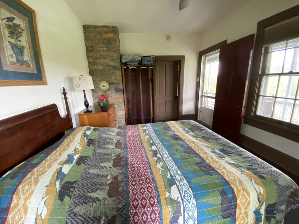 Bedroom 1 with queen bed opens to the huge screened porch.