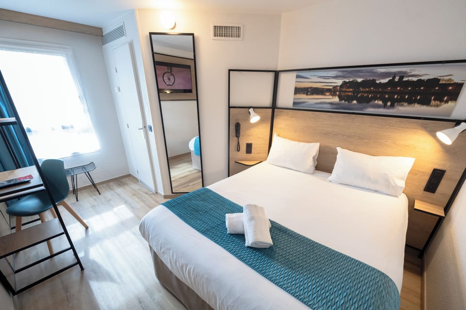 Premium bedding, desk, laptop workspace, blackout drapes