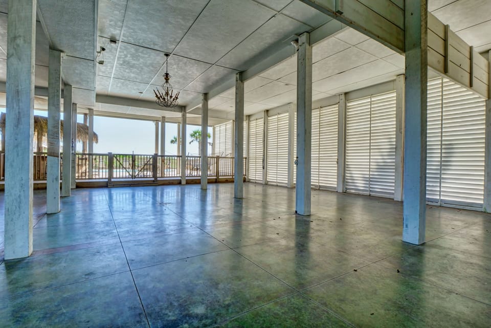 Large, open space under the house. Stained concrete floor with dance floor.