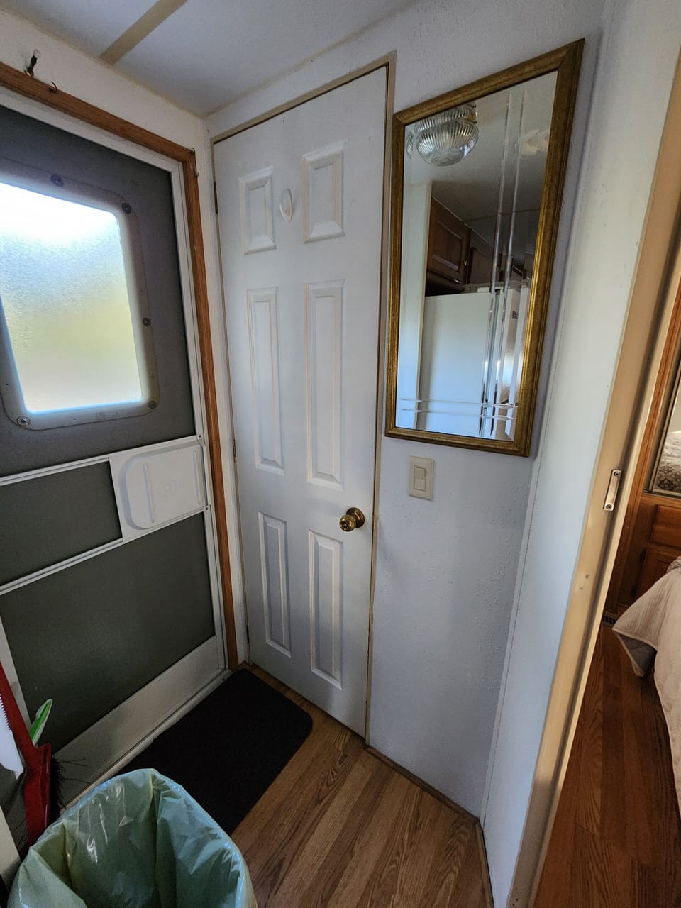 Back door with screen door to allow air flow and provide access to the yard.