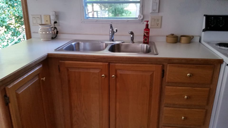 Kitchen with ample cabinet space and new sink.