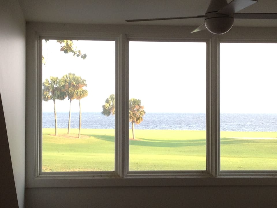view of bay and golf course from loft bedroom