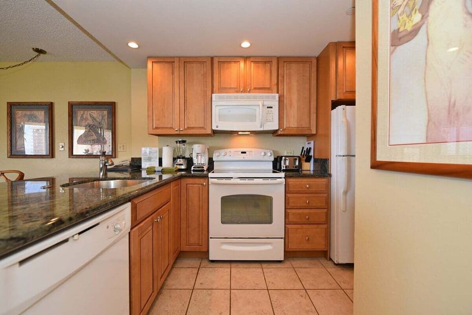 Functional kitchen with white appliances and wooden cabinets