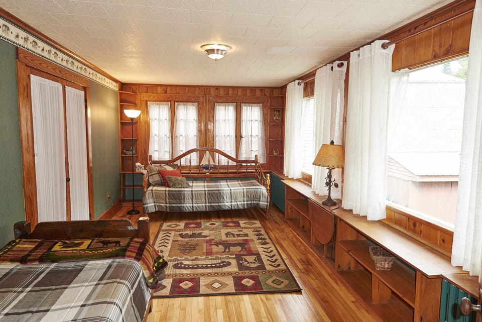 Enclosed heated porch or study/den or home office with private entrance.