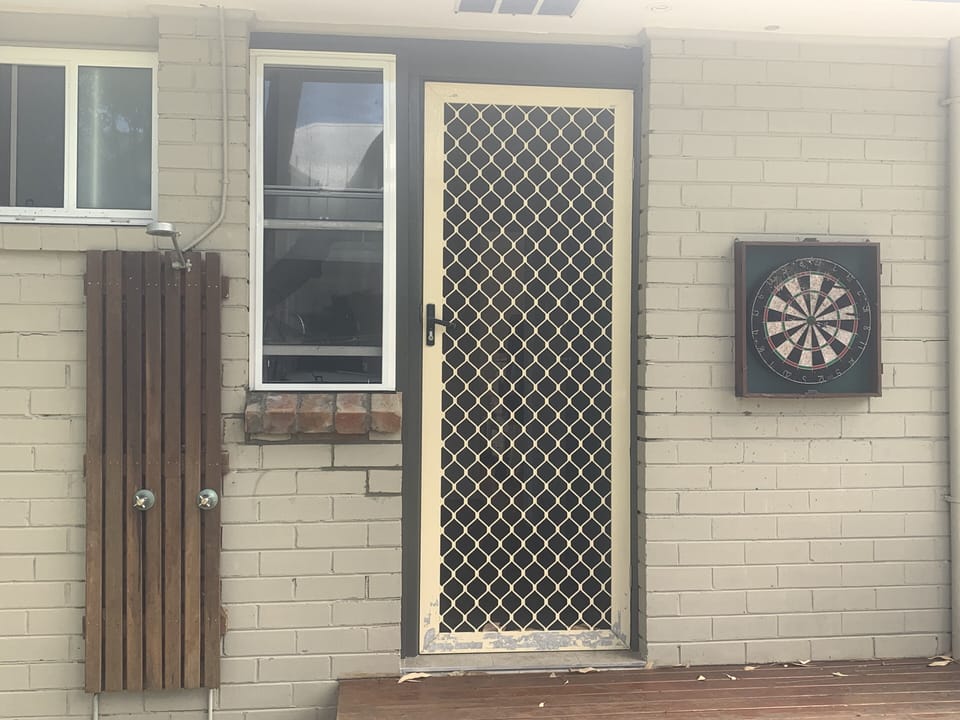 Outdoor shower and dart board