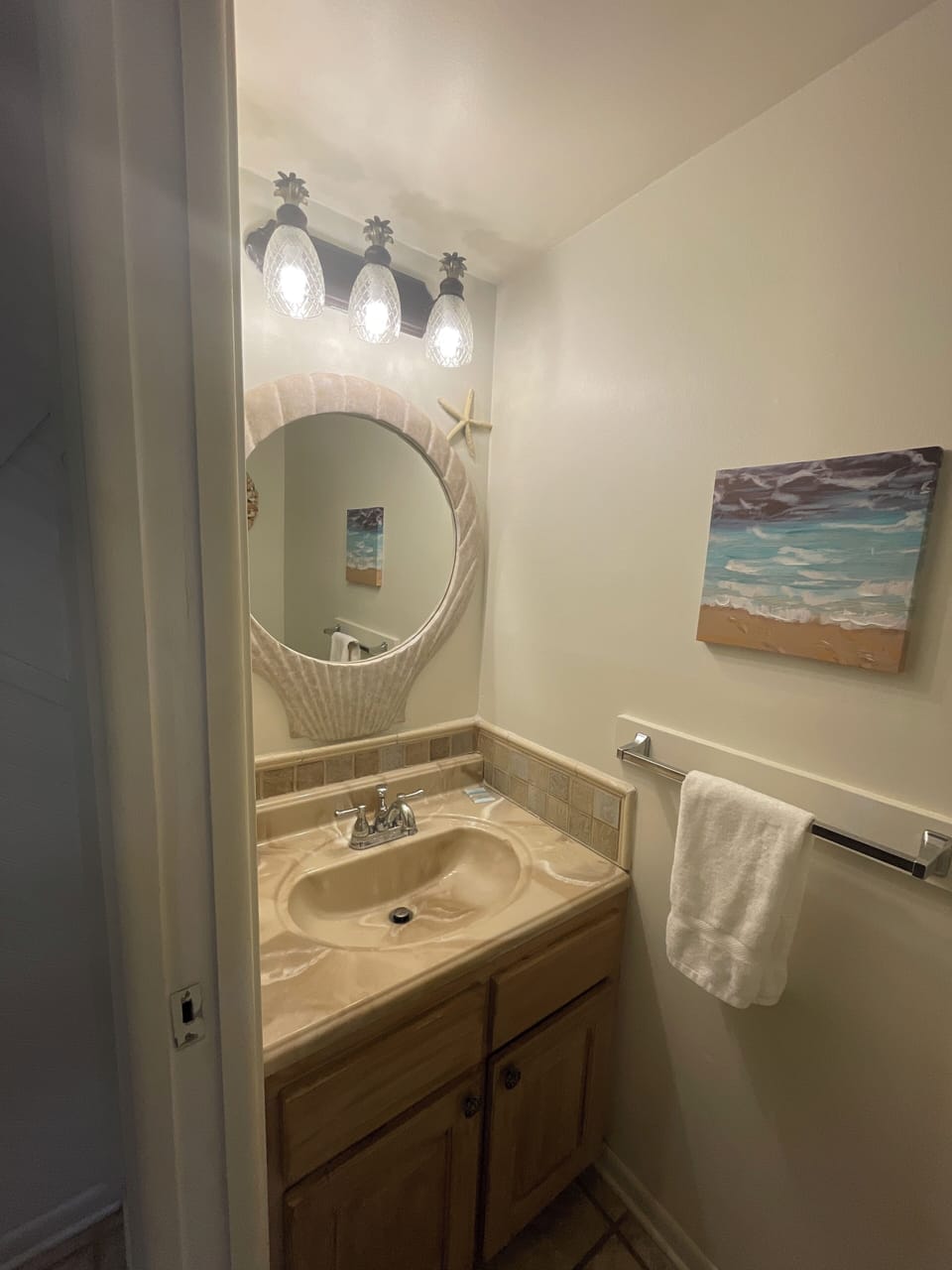 Half bath with pocket door conveniently located on the main level