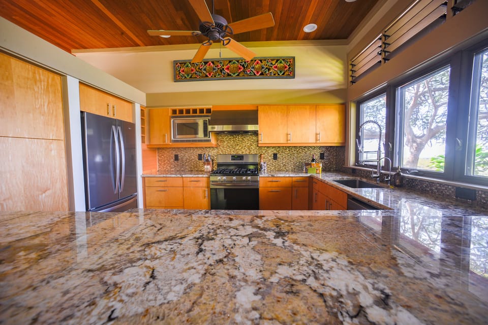 The kitchen is lovely with granite, tile, hardwood, and stainless.
