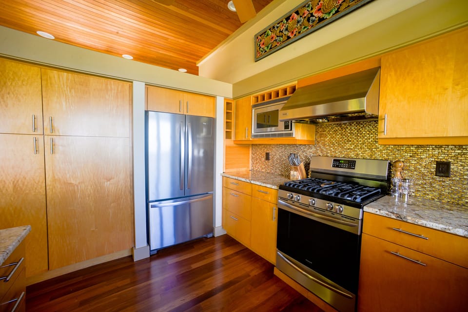 The cabinets are stocked with a complete set of cooking supplies.