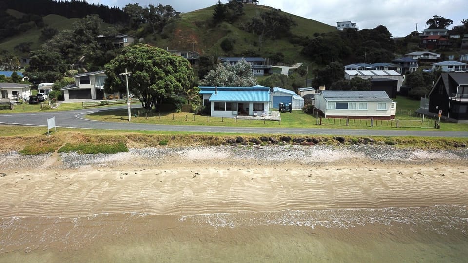 Absolute beachfront with single lane residents access road in front